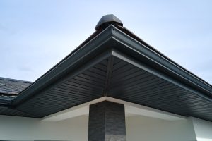 Brown seamless gutters on the corner of a house 